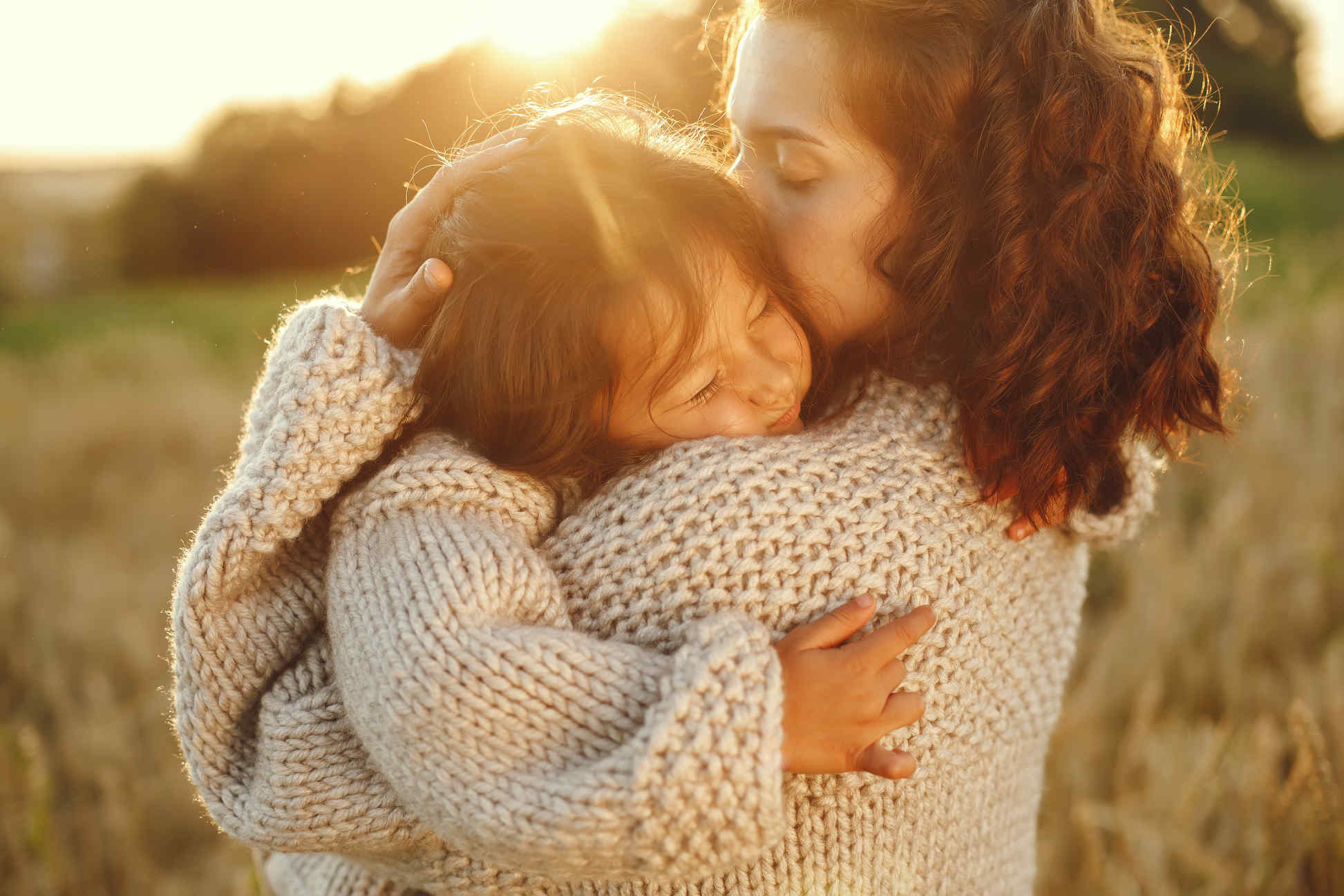 Family in a summer field. Sensual photo. Cute little girl in a knited sweater.